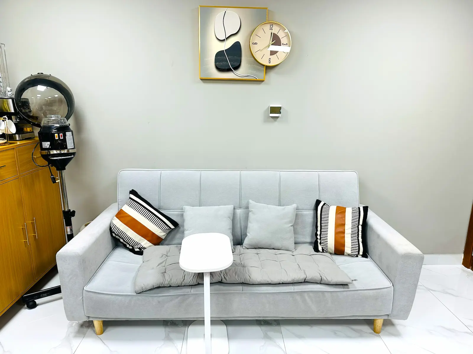 comfortable waiting area with sofa at Kings Afro Barbershop in JVC Dubai