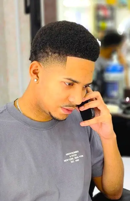 clean low fade haircut with sharp lineup at Kings Afro Barbershop in JVC Dubai