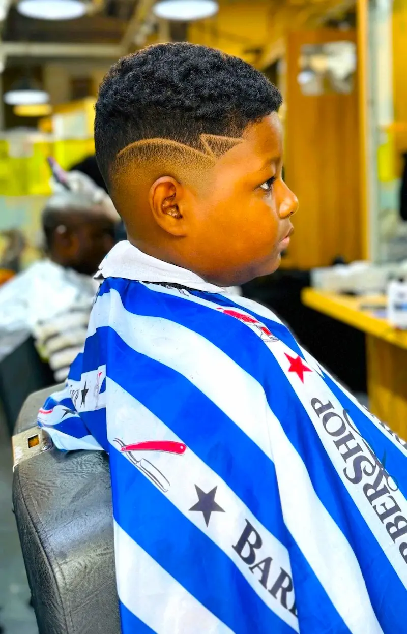 kids fade haircut with clean design line at Kings Afro Barbershop in JVC Dubai