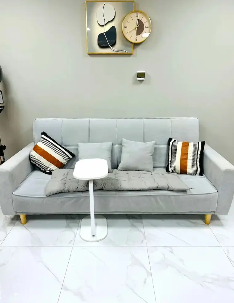 comfortable waiting area with sofa at Kings Afro Barbershop in JVC Dubai